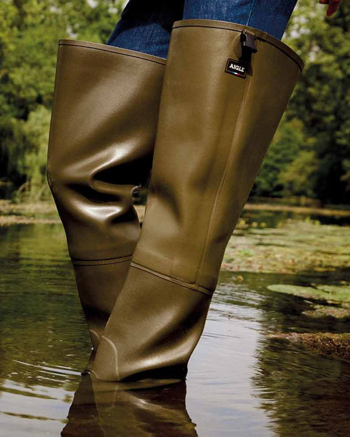 Khaki coloured Aigle Mens Truite Versatile Fishing Waders on lake background #colour_khaki