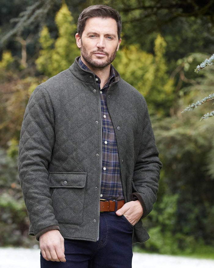 Olive coloured Alan Paine Mens Richmond Quilted Jacket on tree background #colour_olive