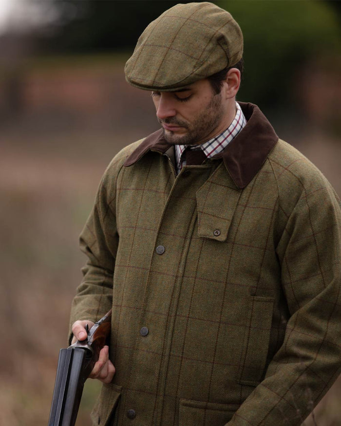 Lichen coloured Alan Paine Rutland Waterproof Tweed Shooting Coat on forest background #colour_lichen