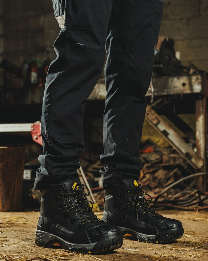 Black Coloured Amblers Safety FS32 Waterproof Safety Boots on a workspace background  #colour_black