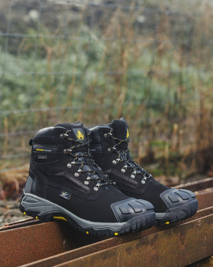 Black Coloured Amblers Safety Mens FS987 Waterproof Safety Boots on a blurry background #colour_black