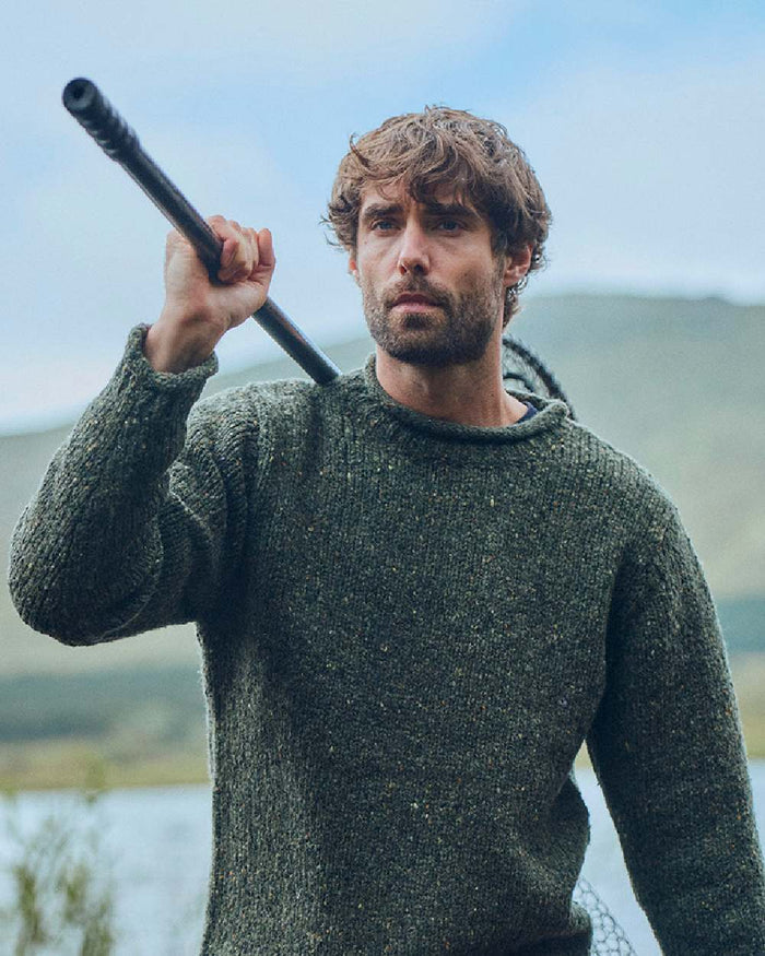 Green Coloured Aran Donegal Wool Crew Neck Sweater on blurry background #colour_green