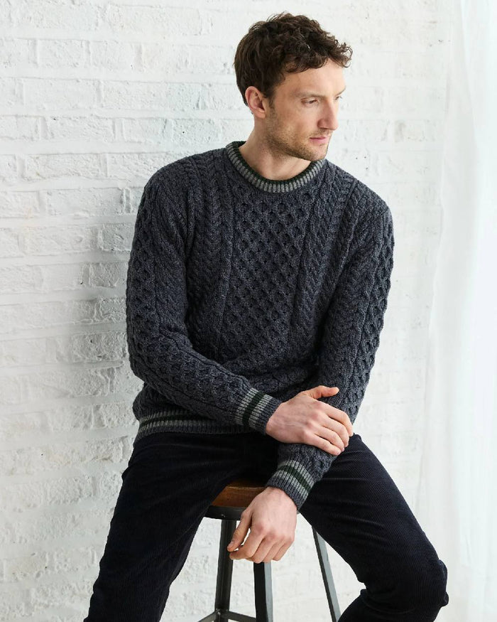 Dark Grey Coloured Aran Mens Inishbeg Stripe Crewneck Merino Sweater on indoor background #colour_dark-grey