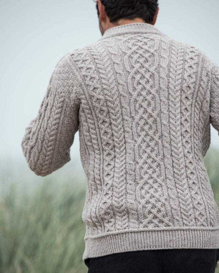 Oat Coloured Aran Supersoft Merino 1/2 Zip Jumper on blurry background #colour_oat