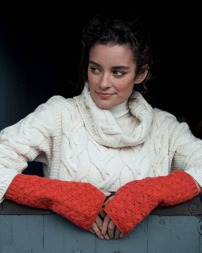 Coral Coloured Aran Supersoft Merino Fingerless Gloves on window background #colour_coral