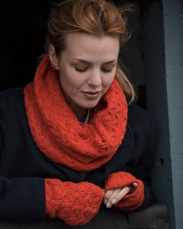Coral Coloured Aran Supersoft Merino Fingerless Gloves on window background #colour_coral