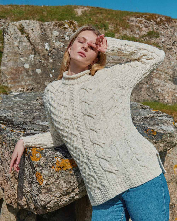 Cream Coloured Aran Womens Calla Aysmmetrical Pattern Sweater on outdoor background #colour_cream