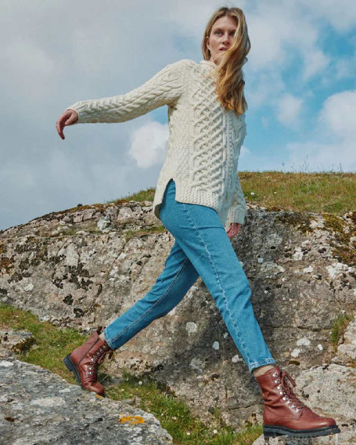 Cream Coloured Aran Womens Calla Aysmmetrical Pattern Sweater on outdoor background #colour_cream