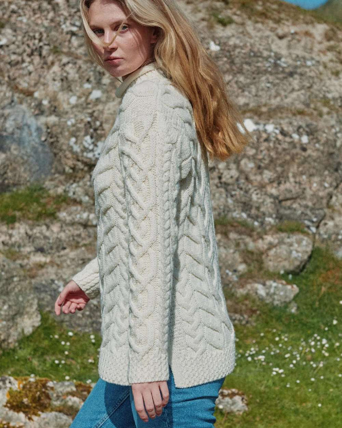 Cream Coloured Aran Womens Calla Aysmmetrical Pattern Sweater on outdoor background #colour_cream