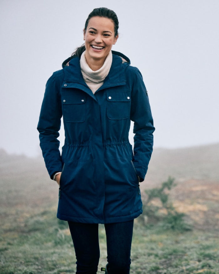 Navy Coloured Ariat Womens Argentium Waterproof Parka On A Forest Background #colour_navy