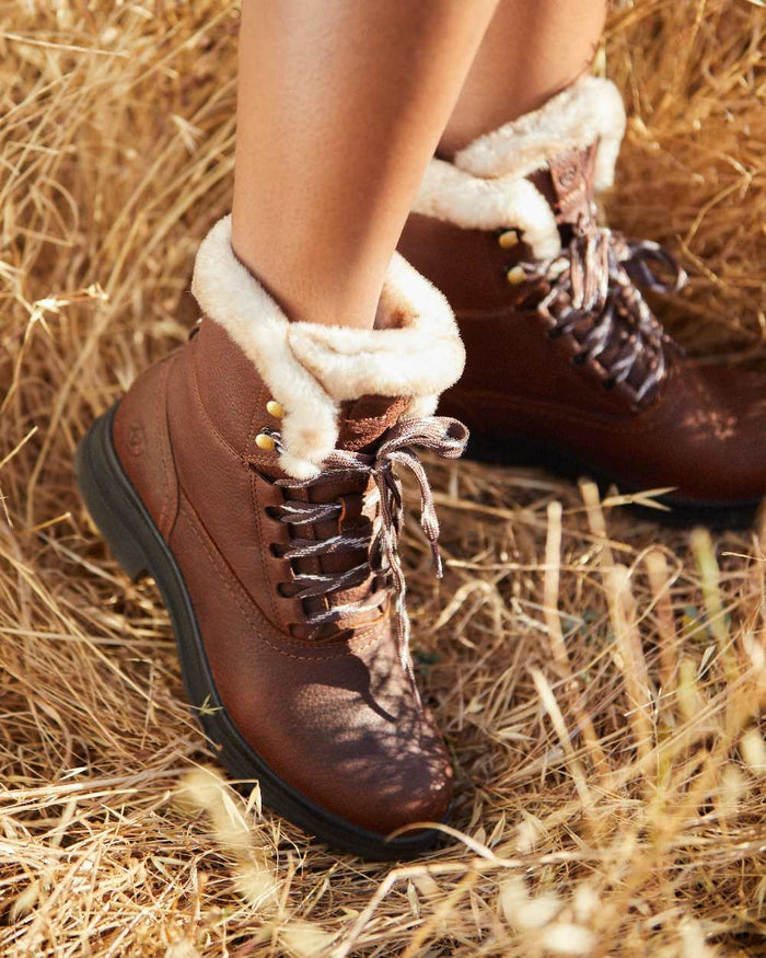 Dark Brown coloured Ariat Womens Harper Sherpa Waterproof Boots on hay background #colour_dark-brown