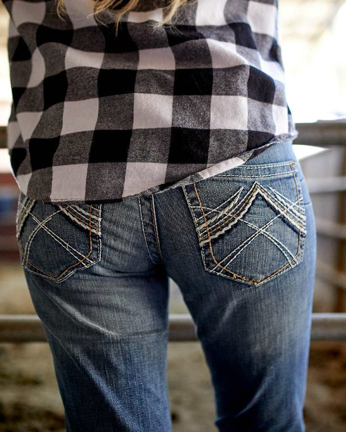 Rainstorm Coloured Ariat Womens Real Mid Rise Stretch Whipstitch Boot Cut Jeans on blurry background #colour_rainstorm
