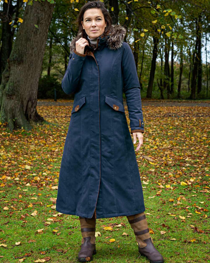 Dark Blue coloured Baleno Kensington Warm Long Waterproof Coat on countryside background #colour_dark-blue