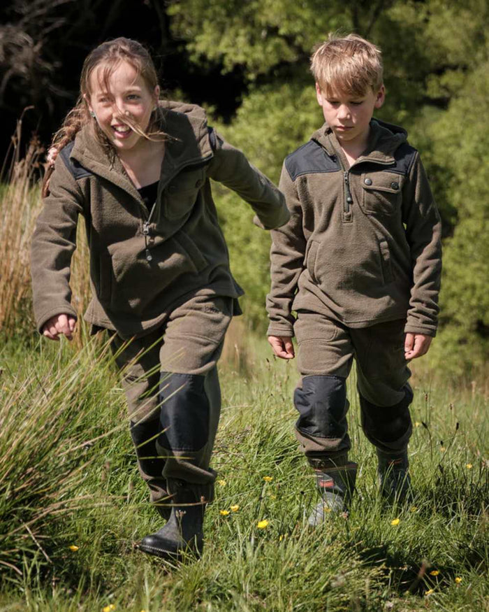 Khaki Black coloured Betacraft Childrens Quest Fleece Bushshirt on forest background #colour_khaki-black