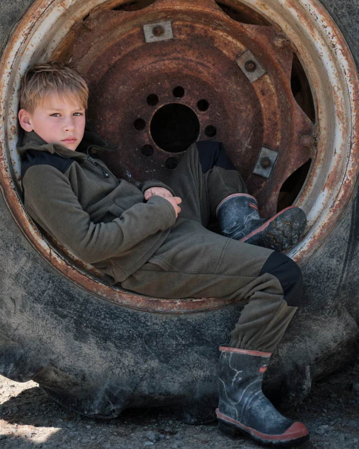 Khaki Black coloured Betacraft Childrens Quest Fleece Bushshirt on tyre background #colour_khaki-black
