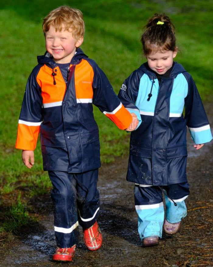 Navy Pale Blue coloured Betacraft Childrens Tuffbak Waterproof Parka on grassy background #colour_navy-pale-blue
