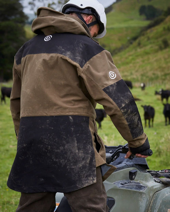 Taupe coloured Betacraft Mamaku Jacket on mountain background #colour_taupe