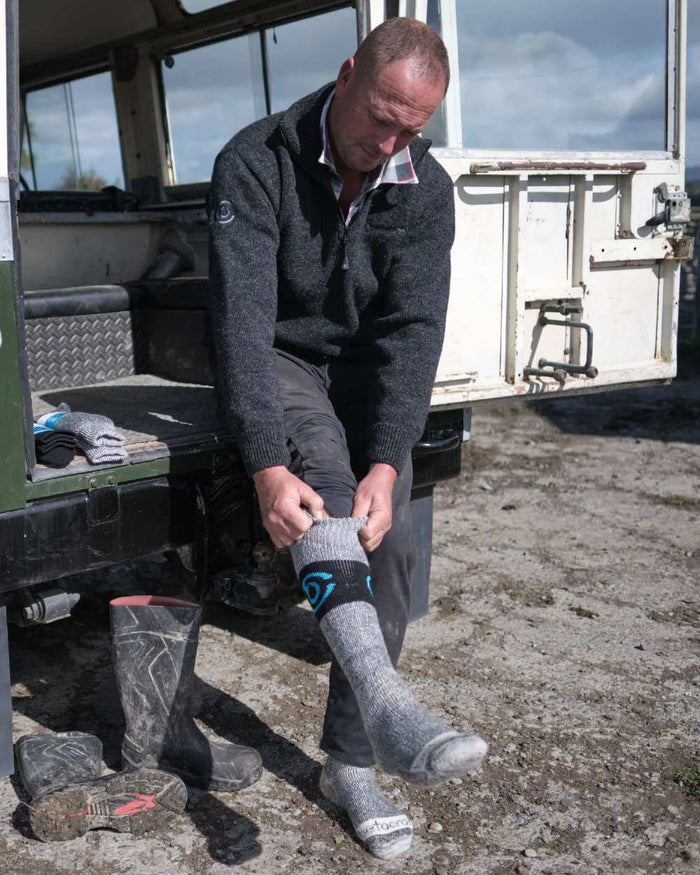 Grey coloured Betacraft Merino Full Length Socks on jeep background #colour_grey