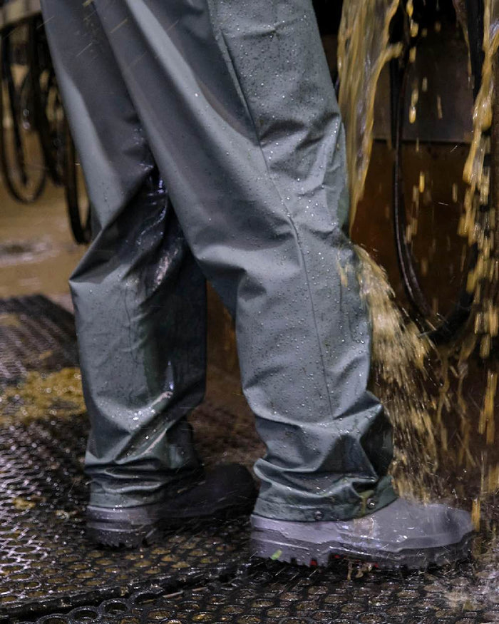 Green coloured Betacraft Technidairy Bib Overtrousers on stable background #colour_green