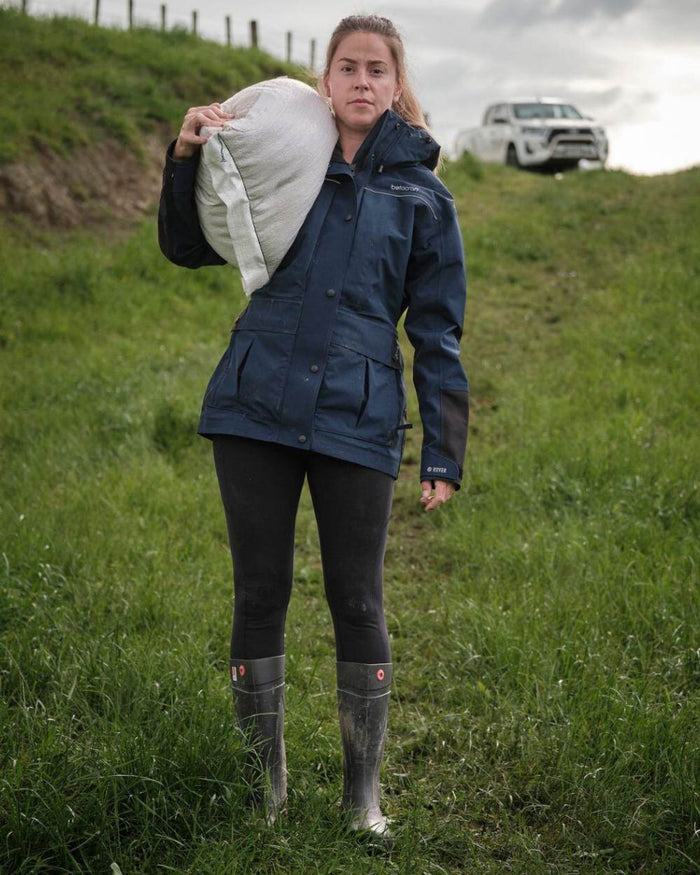 Dark Navy coloured Betacraft Womens Rover Jacket on farm background #colour_dark-navy