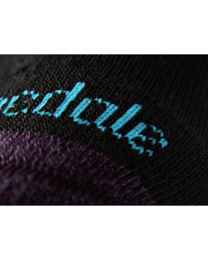 Close up of Black/Purple coloured Bridgedale Womens Lightweight Merino Performance Socks on white background #colour_black-purple