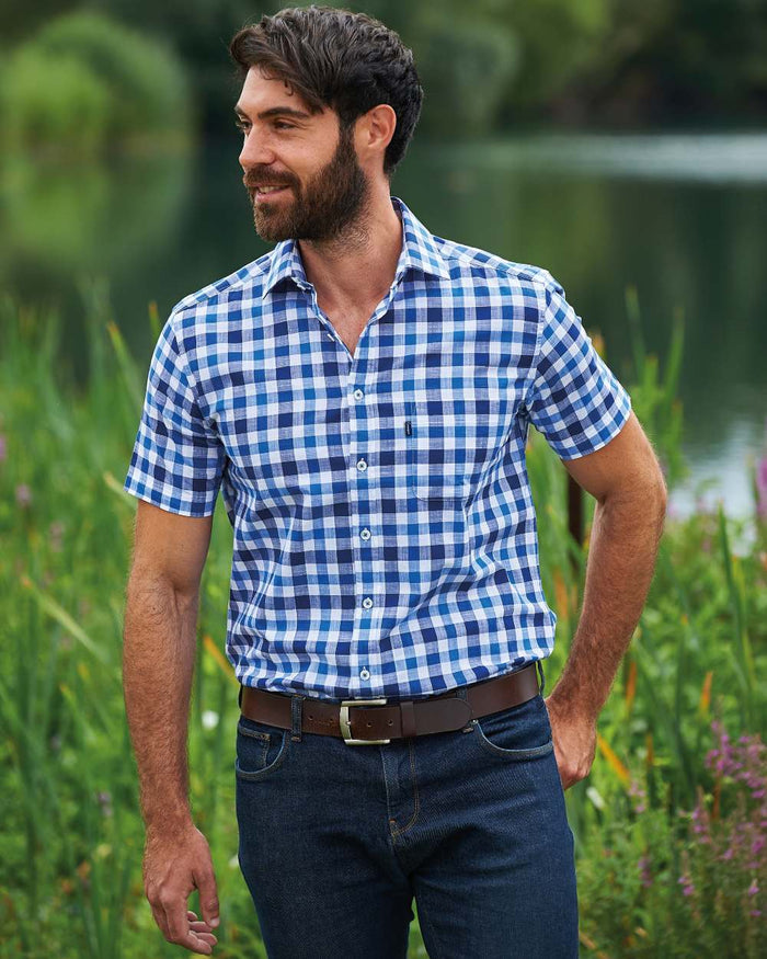 Blue coloured Champion Holkham Short Sleeved Shirt on river background #colour_blue