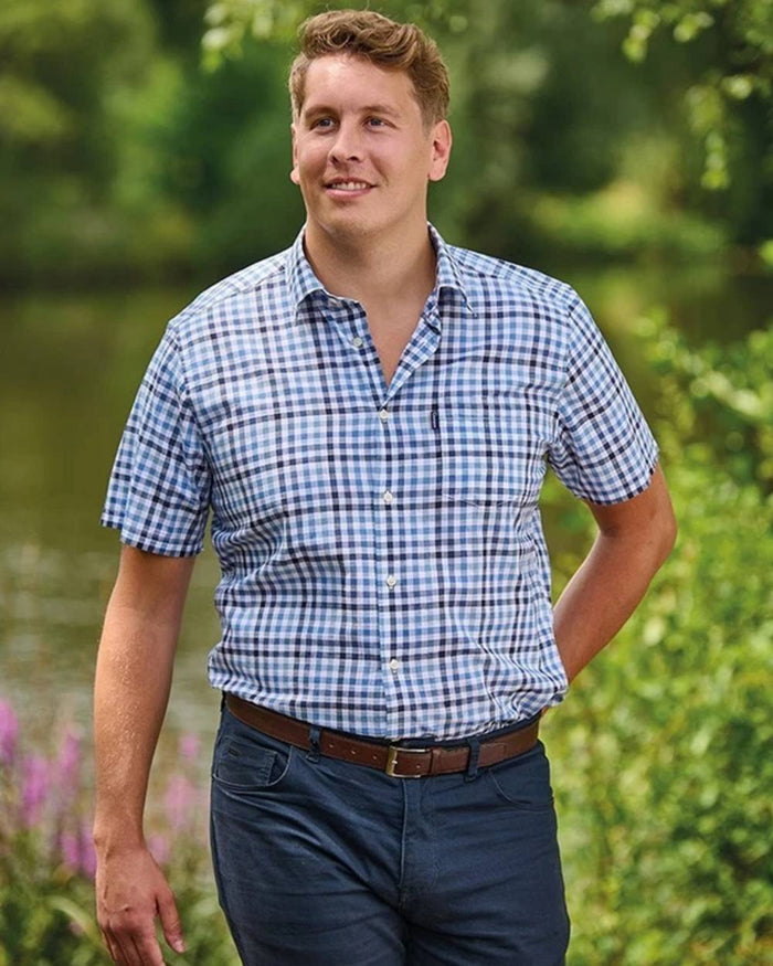 Blue coloured Champion Mens Broadstairs Short Sleeve Shirt on lake background #colour_blue