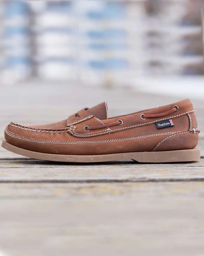 Walnut Coloured Chatham Mens Gaff II G2 Slip On Leather Boat Shoes on blurry background #colour_walnut