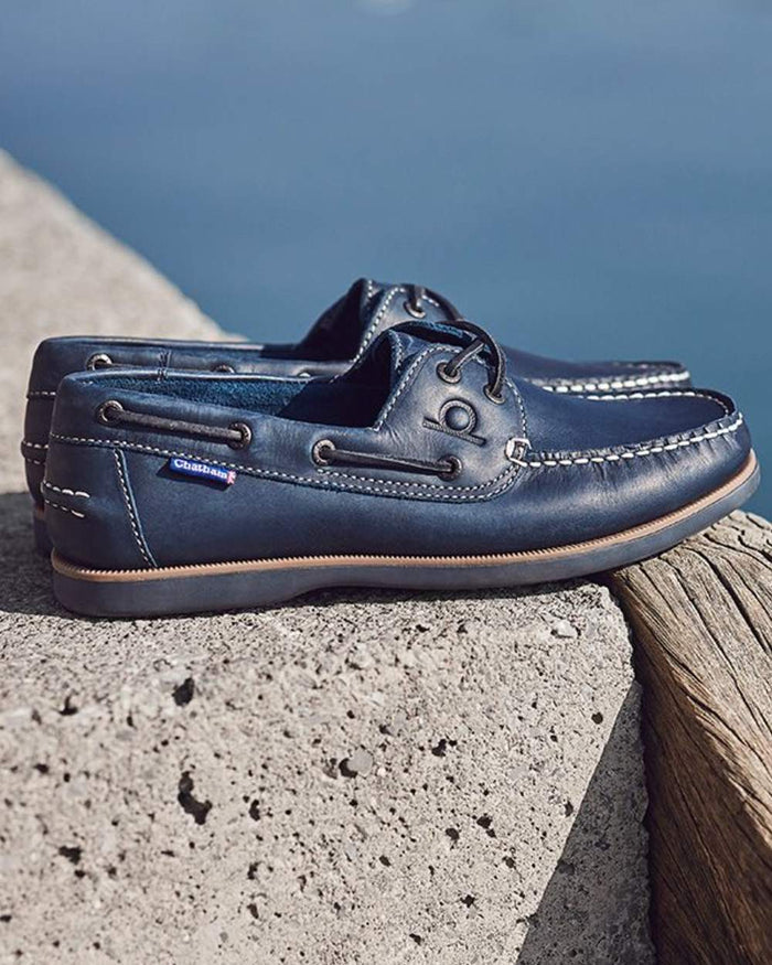 Navy coloured Chatham Mens Whitstable Premium Leather Boat Shoes on sea background #colour_navy