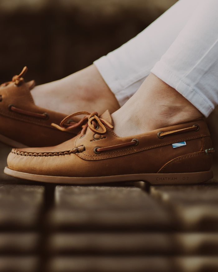 Walnut Coloured Chatham Womens Deck II G2 Premium Leather Boat Shoes on outdoor background #colour_walnut