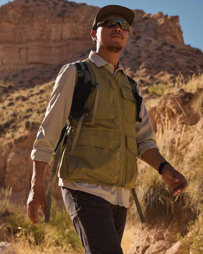 Cardamon coloured Craghoppers Mens NosiLife Sebou Gilet on mountain background #colour_cardamon