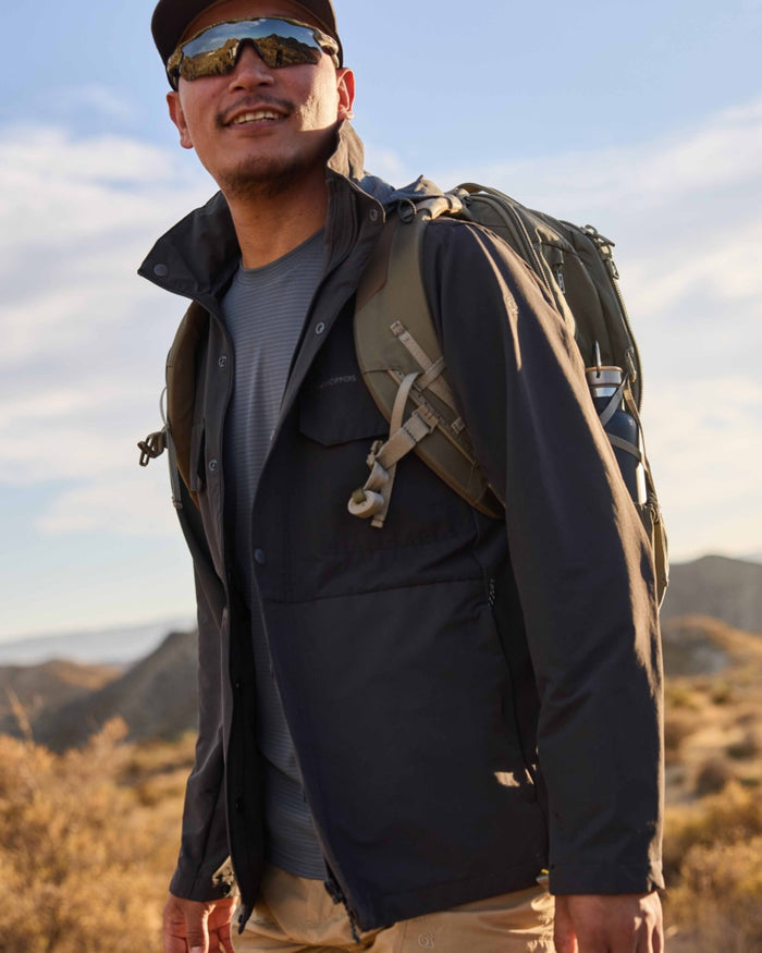 Dark Pewter coloured Craghoppers Mens NosiLife SolarShield+ Long Sleeved T-Shirt on mountain background #colour_dark-pewter