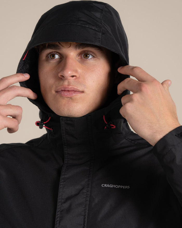 Black coloured Craghoppers Ossus Jacket on beige background #colour_black