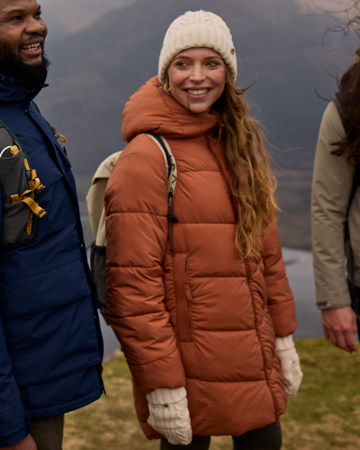 Tawny coloured Craghoppers Womens Kendal Jacket on mountain background #colour_tawny