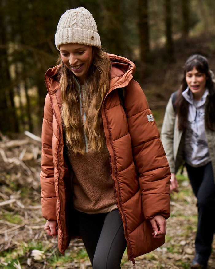 Tawny coloured Craghoppers Womens Kendal Jacket on forest background #colour_tawny