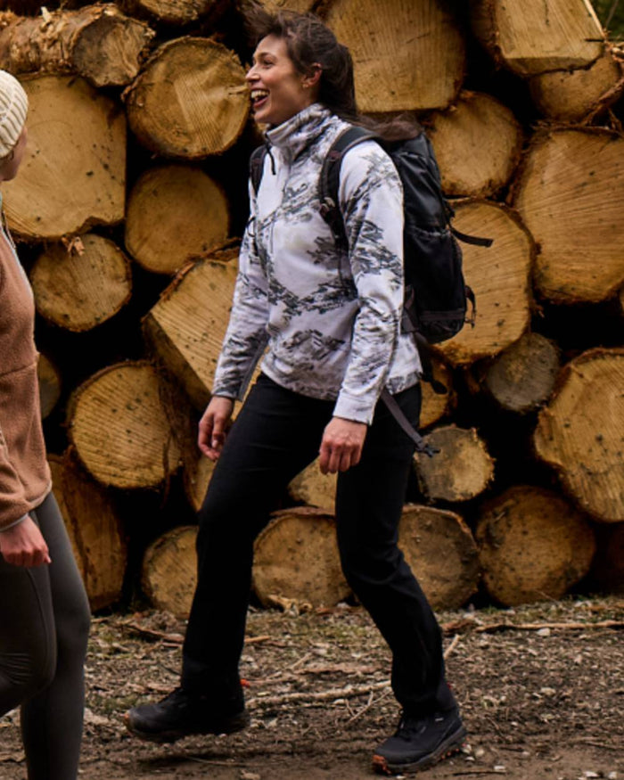 Black coloured Craghoppers Womens Kiwi Pro Cargo Trousers on wood background #colour_black