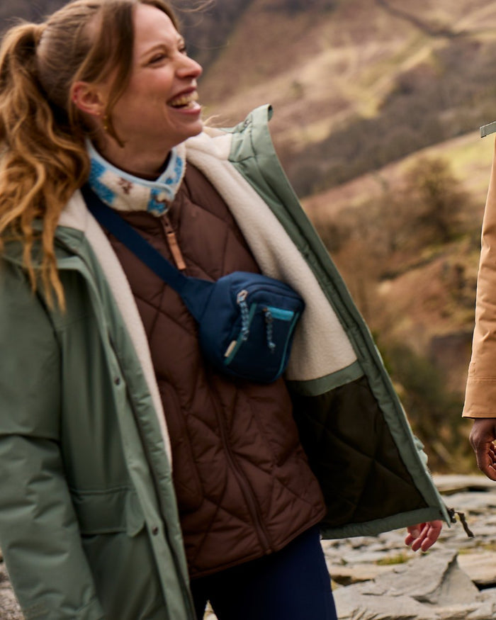 Sage coloured Craghoppers Womens National Trust Crossbill Jacket on mountain background #colour_sage