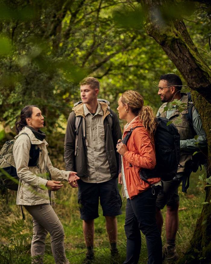 Stone coloured Craghoppers Womens NosiLife Adventure Jacket II on forest background #colour_stone