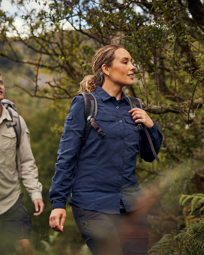 Blue Navy coloured Craghoppers Womens NosiLife Adventure Long Sleeved Shirt III on forest background #colour_blue-navy