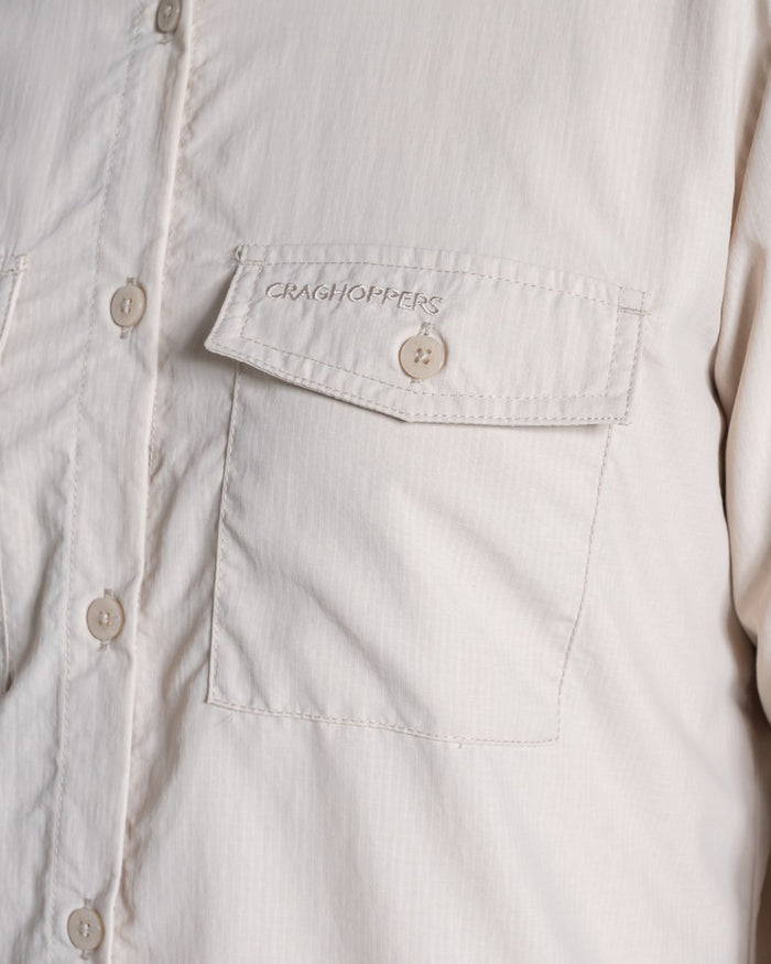 Oyster coloured Craghoppers Womens NosiLife Loukkos Long Sleeved Shirt on white background #colour_oyster