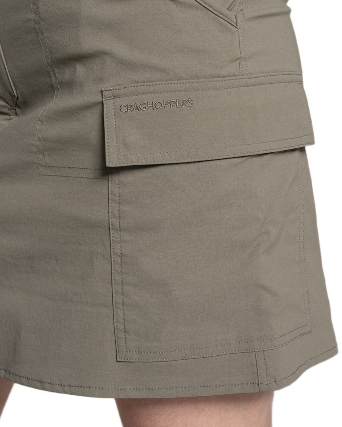 Wild Olive coloured Craghoppers Womens NosiLife Pro Cargo Skort on white background #colour_wild-olive