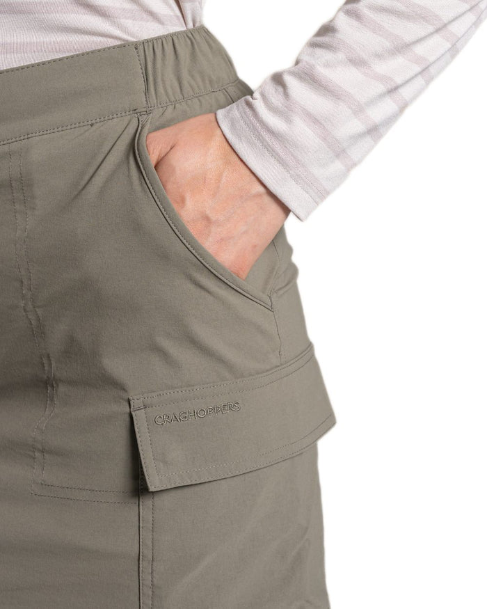 Wild Olive coloured Craghoppers Womens NosiLife Pro Cargo Skort on white background #colour_wild-olive