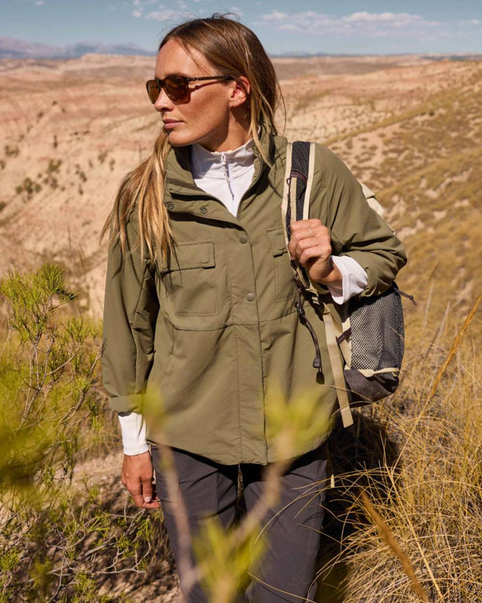 Dark Iron coloured Craghoppers Womens NosiLife Rif Stretch Cargo Trousers on mountain background #colour_dark-iron