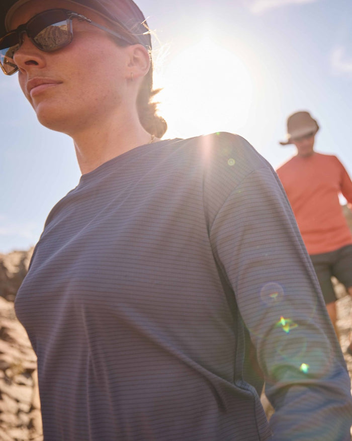 Anthracite coloured Craghoppers Womens NosiLife SolarShield+ Long Sleeved T-Shirt on mountain background #colour_anthracite