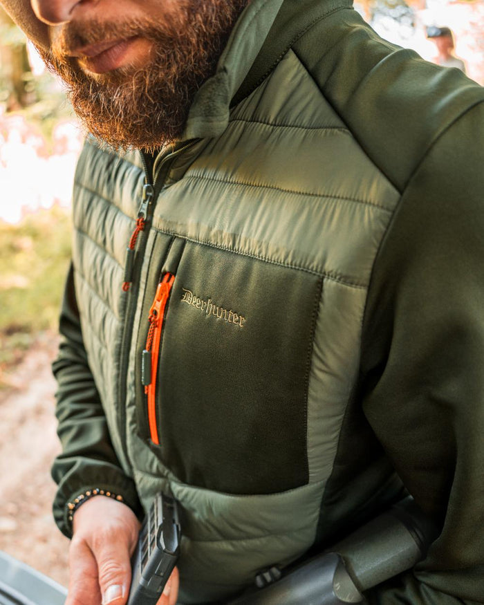 Forest Green coloured Deerhunter Chamois Padded Jacket on forest background #colour_forest-green