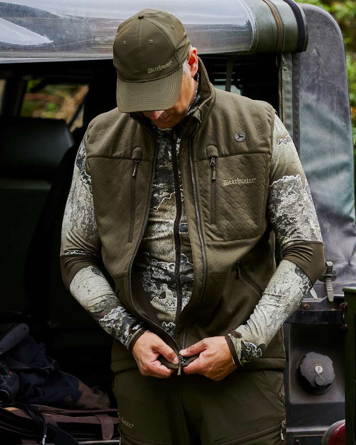 Art Green coloured Deerhunter Excape Softshell Waistcoat on jeep background #colour_art-green