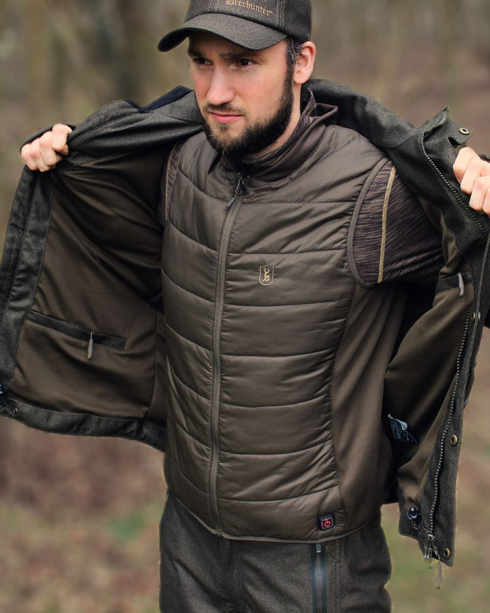 Deep Green Coloured Deerhunter Heat Inner Waistcoat on blurry background #colour_deep-green