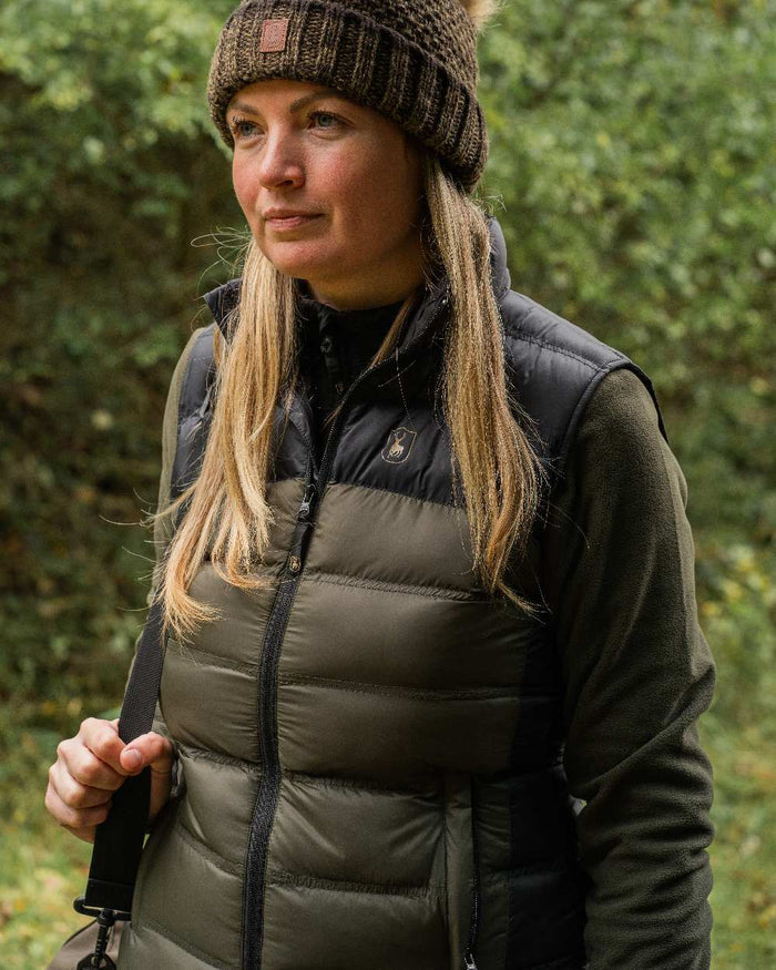 Rifle Green coloured Deerhunter Lady Northward Padded Waistcoat on blurry background #colour_rifle-green