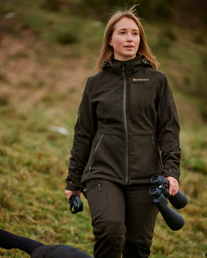 Loden Wood coloured Deerhunter Lady Tatra Active Jacket on Forest background #colour_loden-wood