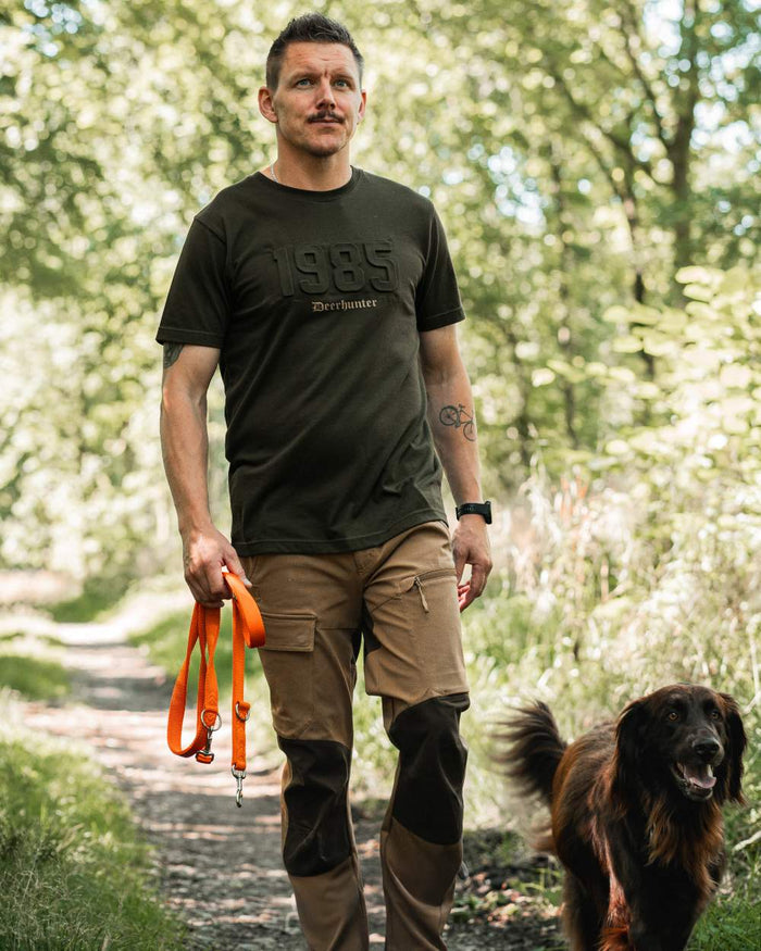 Timber coloured Deerhunter Mens Jubilee T-Shirt on forest background #colour_timber